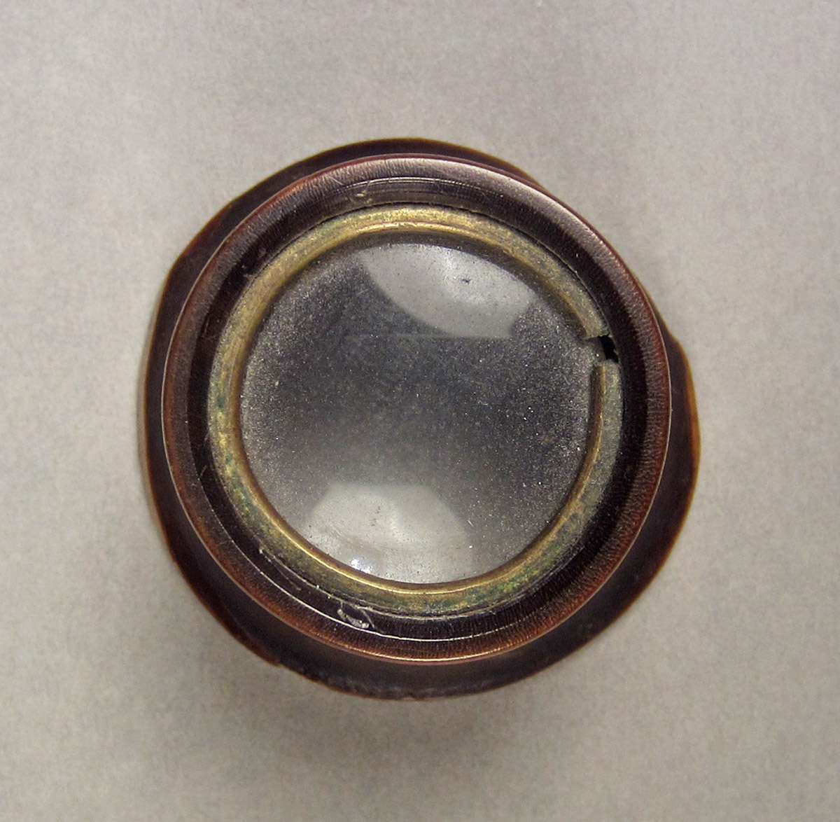 1957.0026.549, Jeweler's loop, side 1