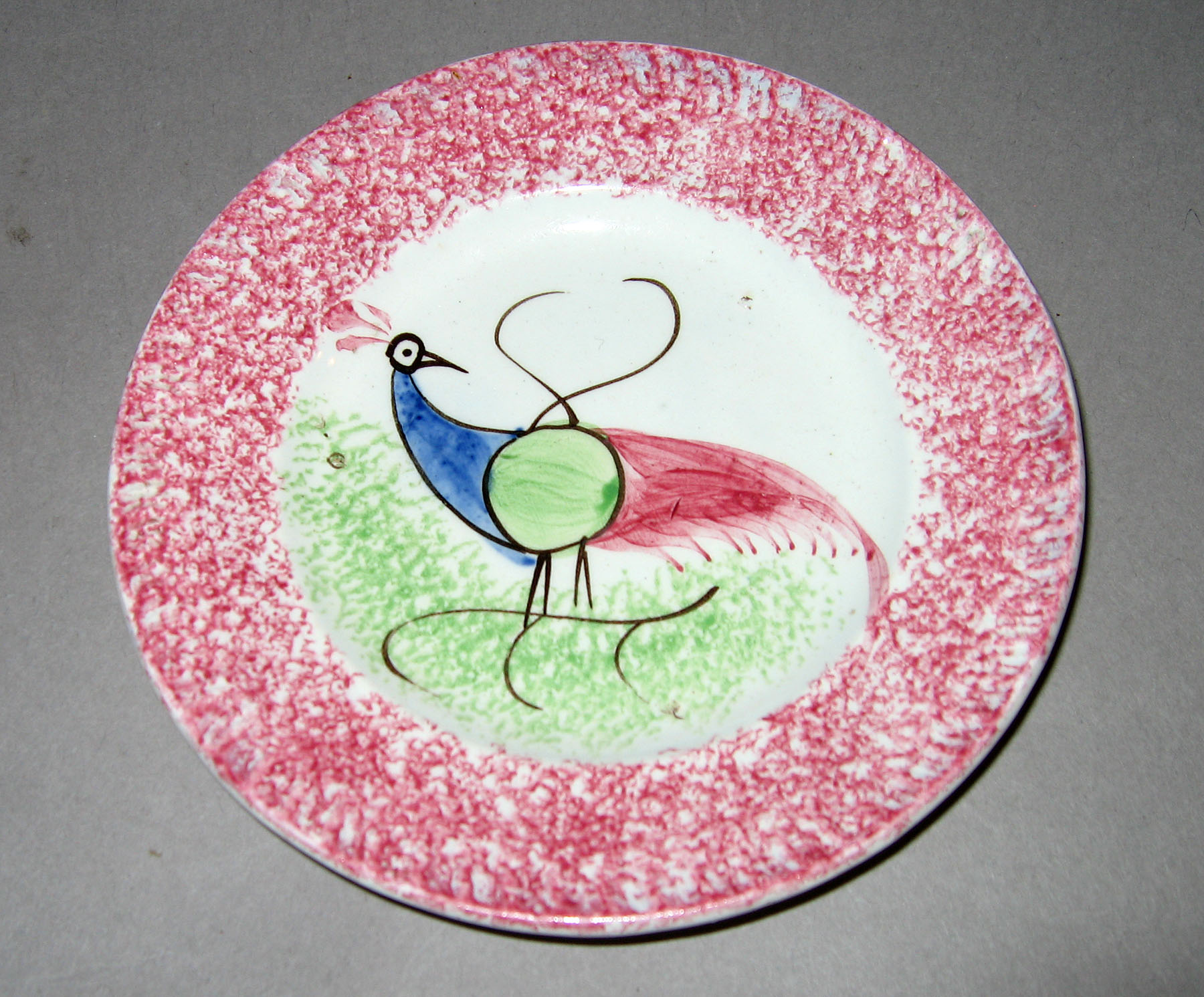 1965.0896.001 Pink spatterware peafowl plate
