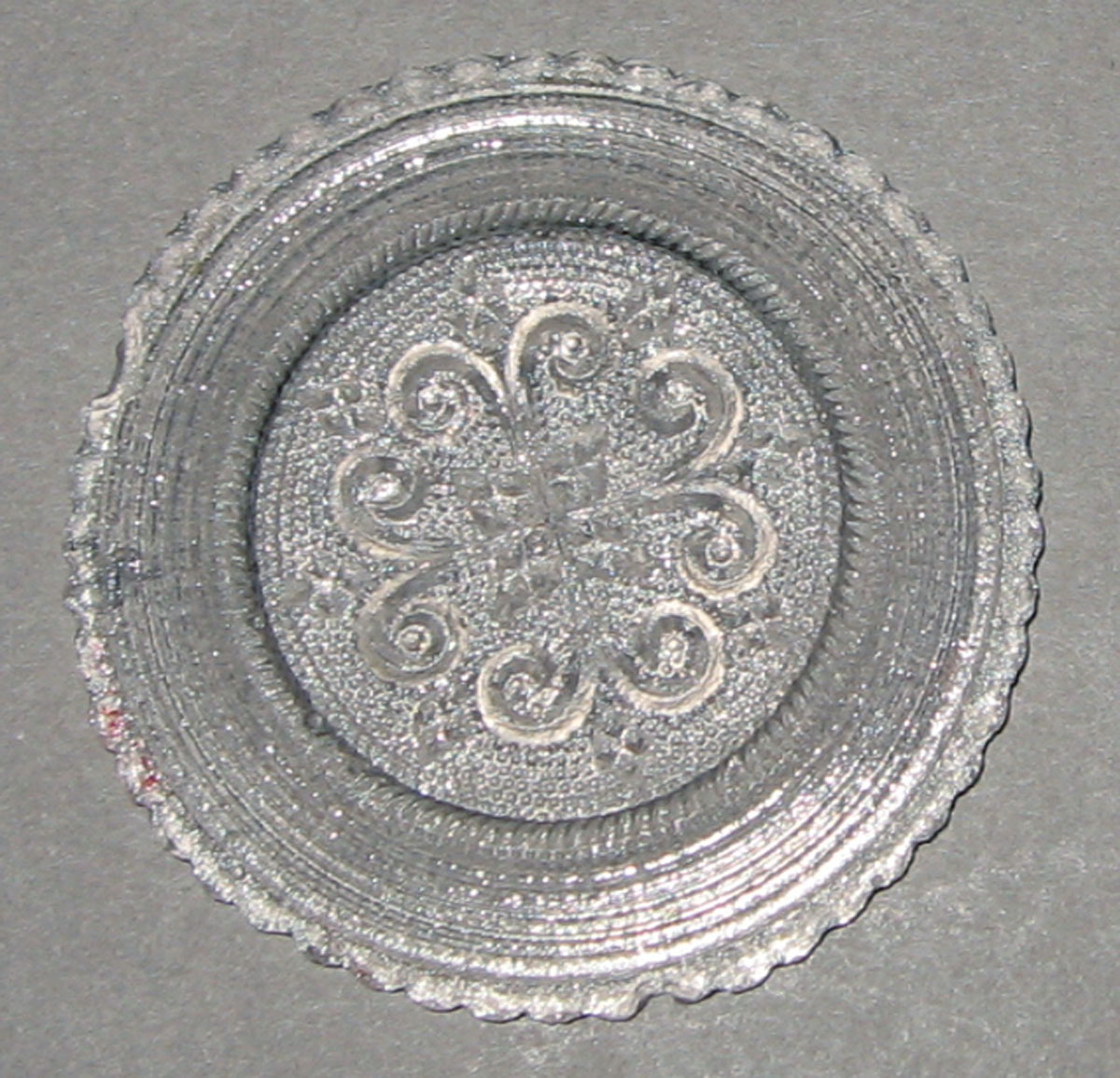 1964.1382 Pressed miniature saucer