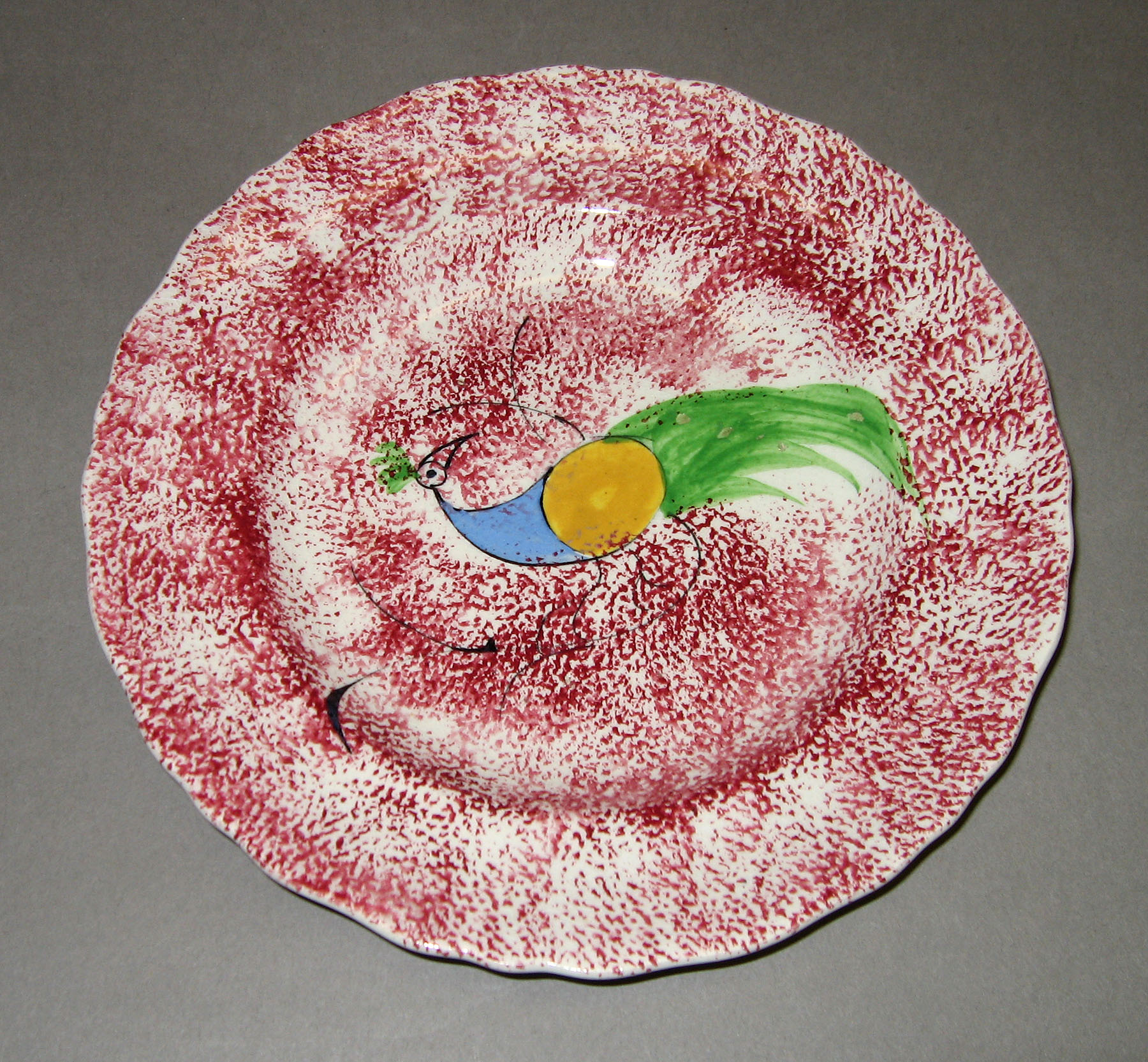 1965.0881.001 Pink spatter plate with peafowl pattern