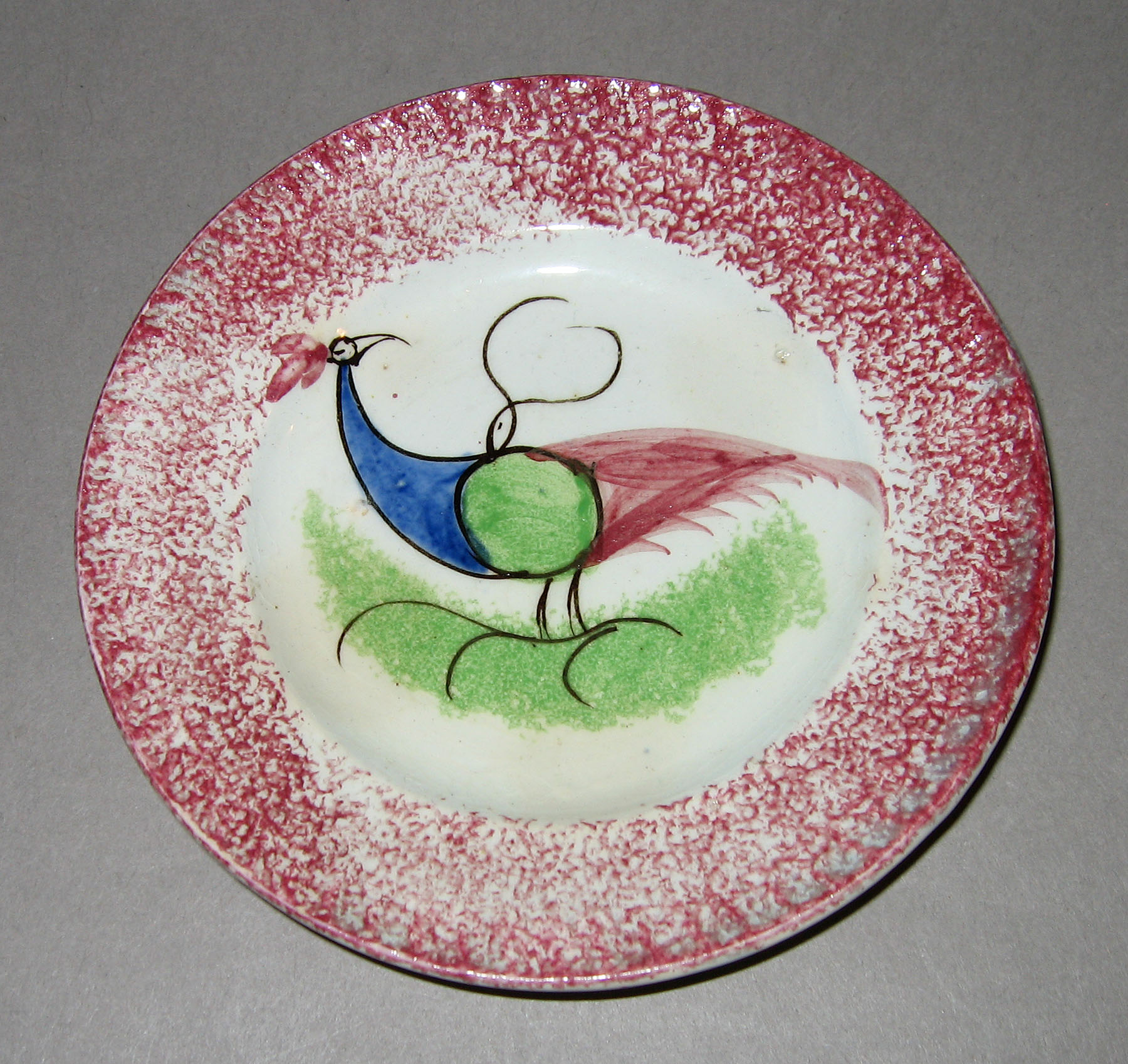 1965.0896.002 Pink spatterware peafowl plate