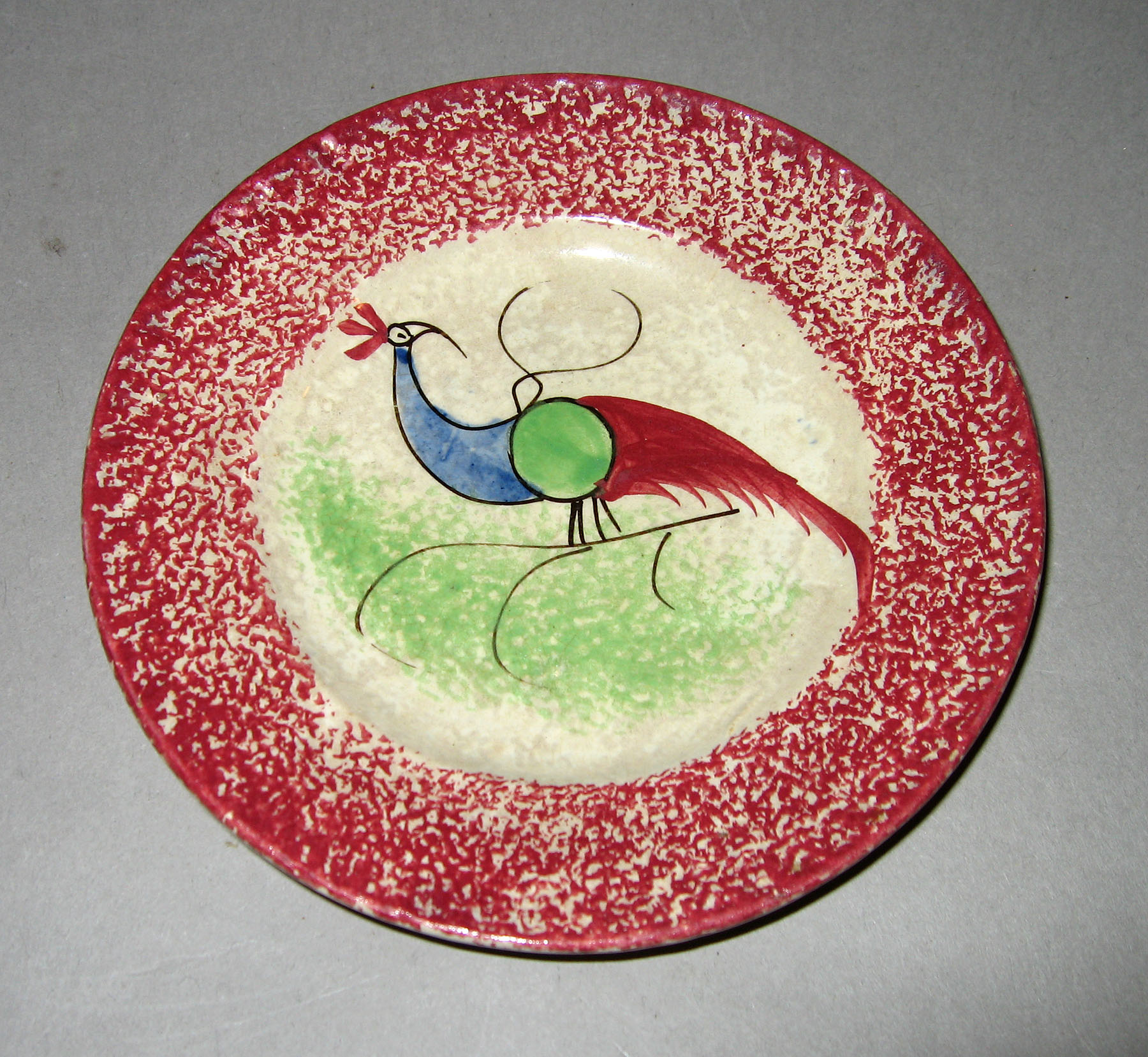 1965.0896.004 Pink spatterware peafowl plate