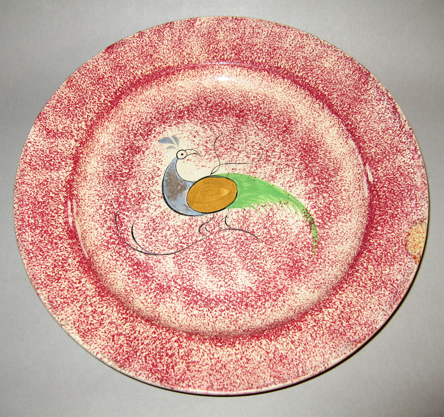 1965.0876.002 Pink spatterware peafowl plate