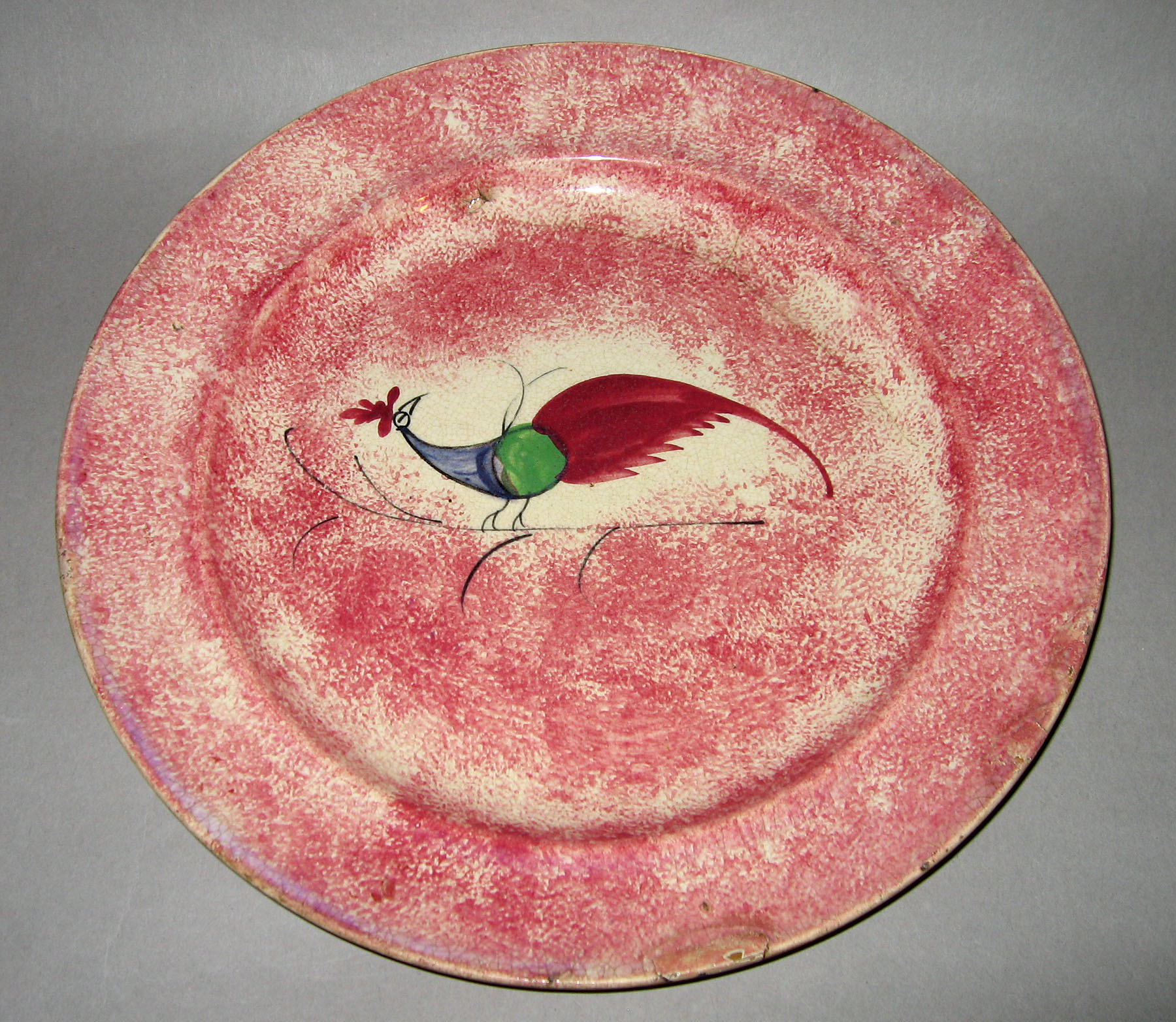 1965.0898 Pink spatterware peafowl plate