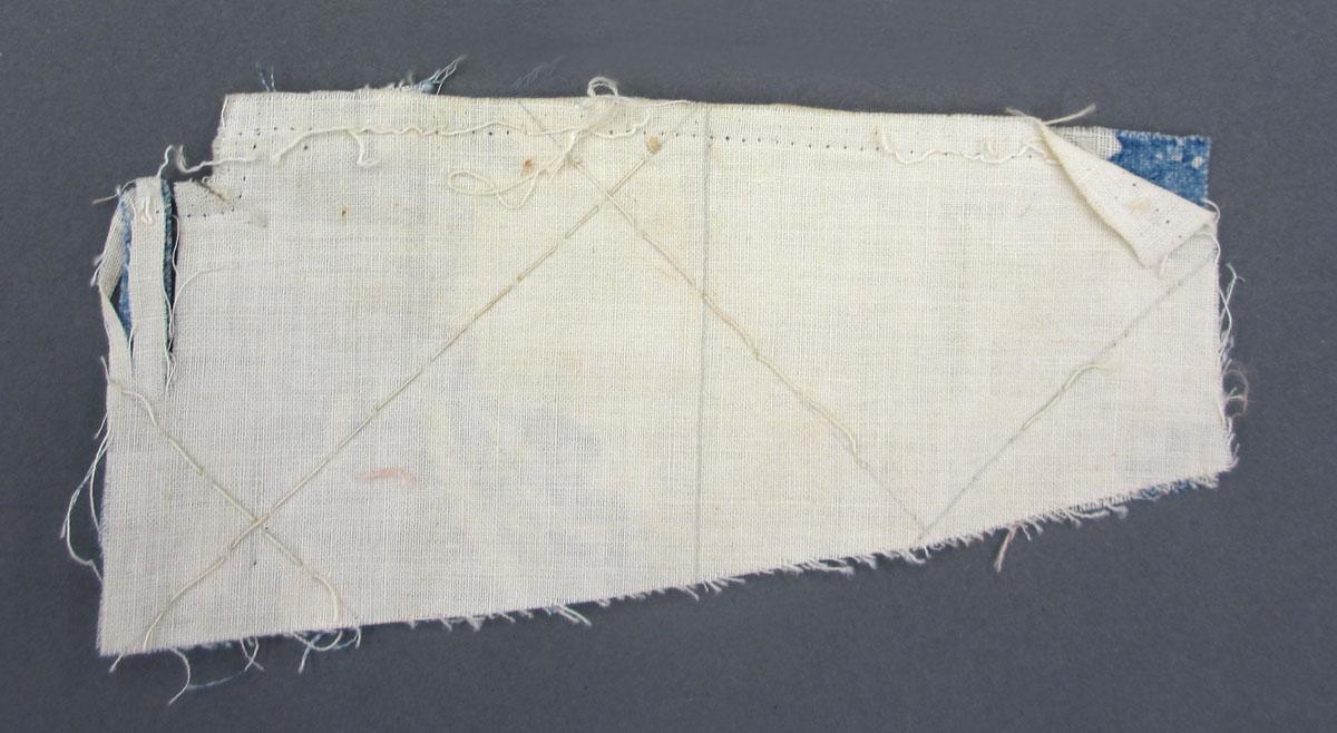1969.8241.013 Textile scrap, printed reverse