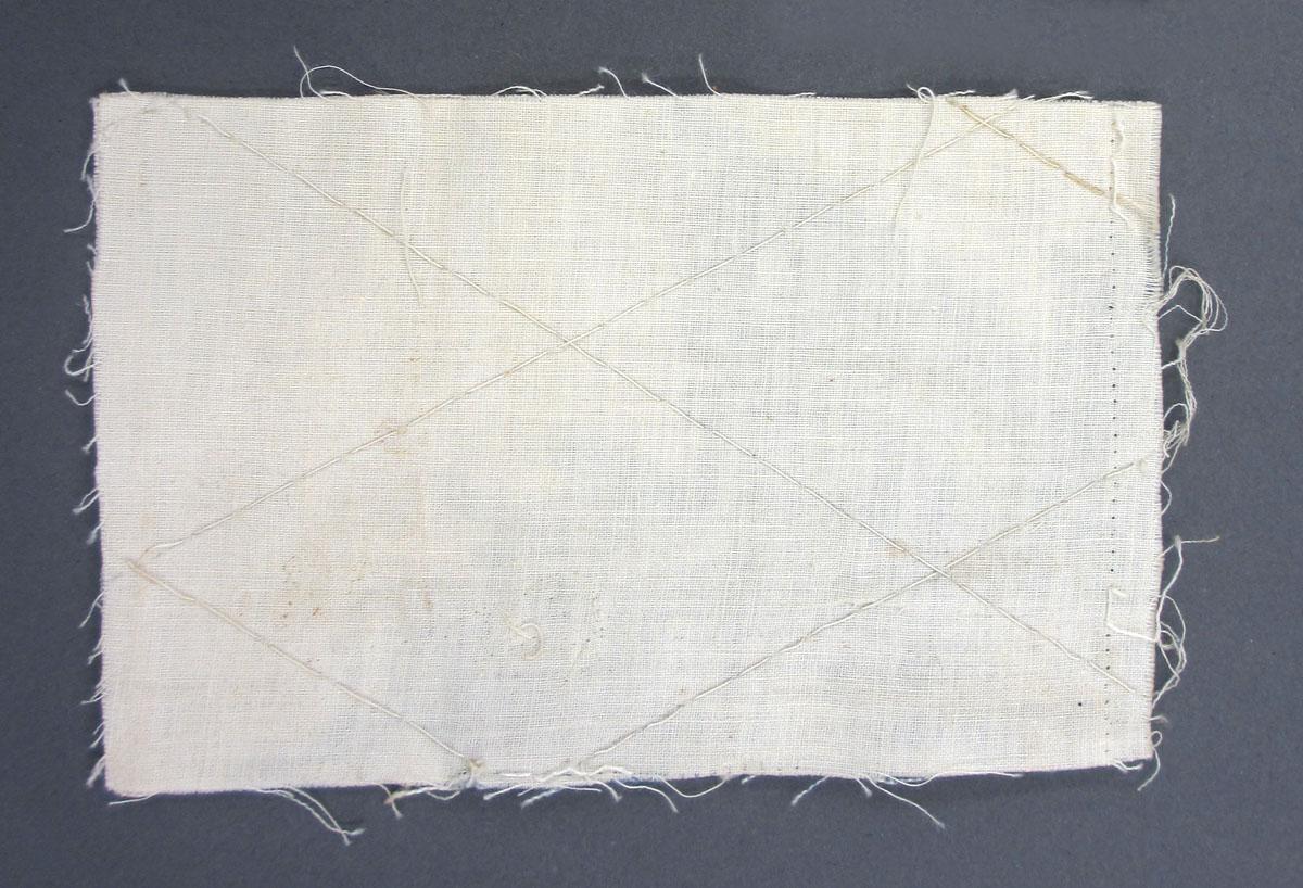 1969.8241.014 Textile scrap, printed reverse