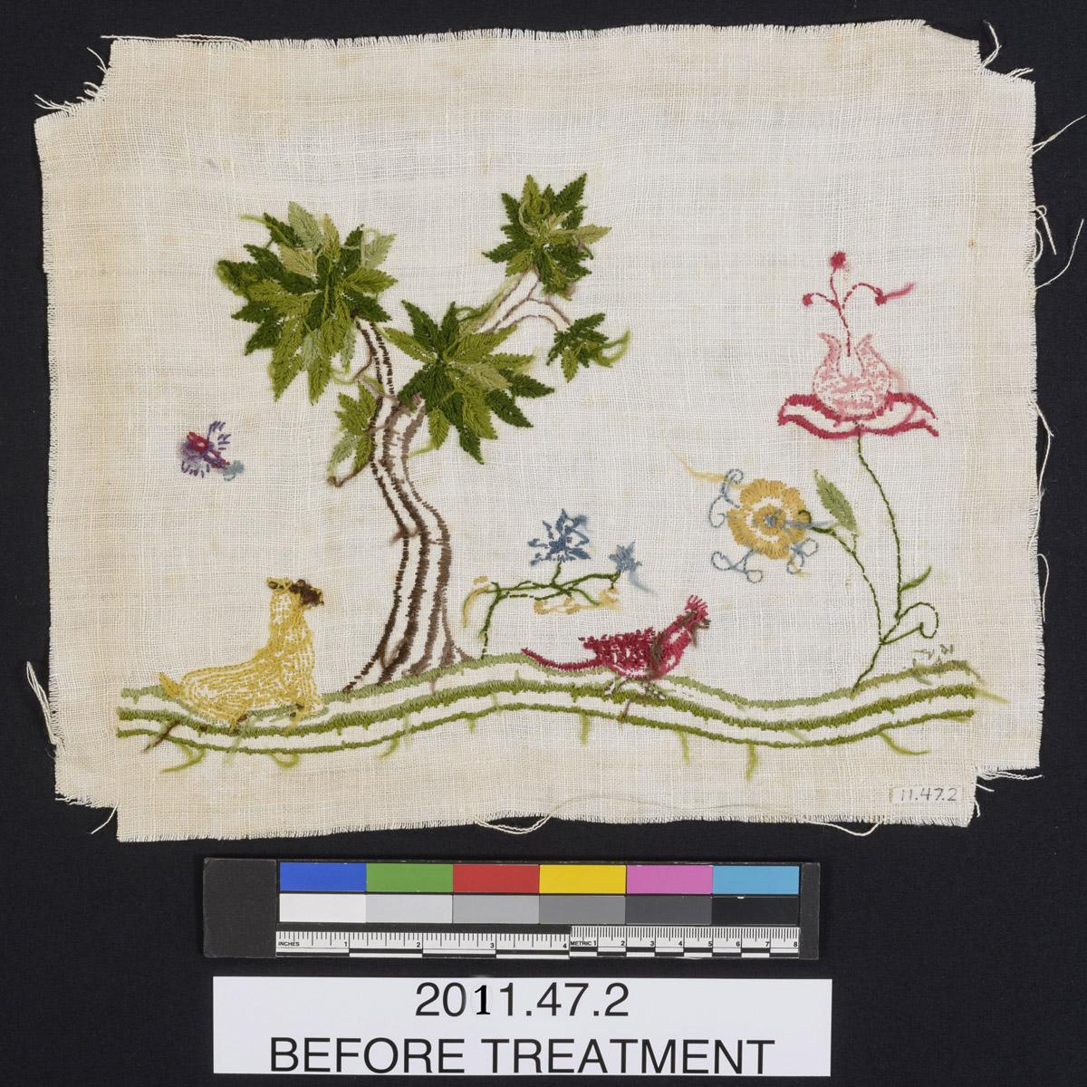 2011.0047.002 Needlework picture, reverse, before conservation treatment