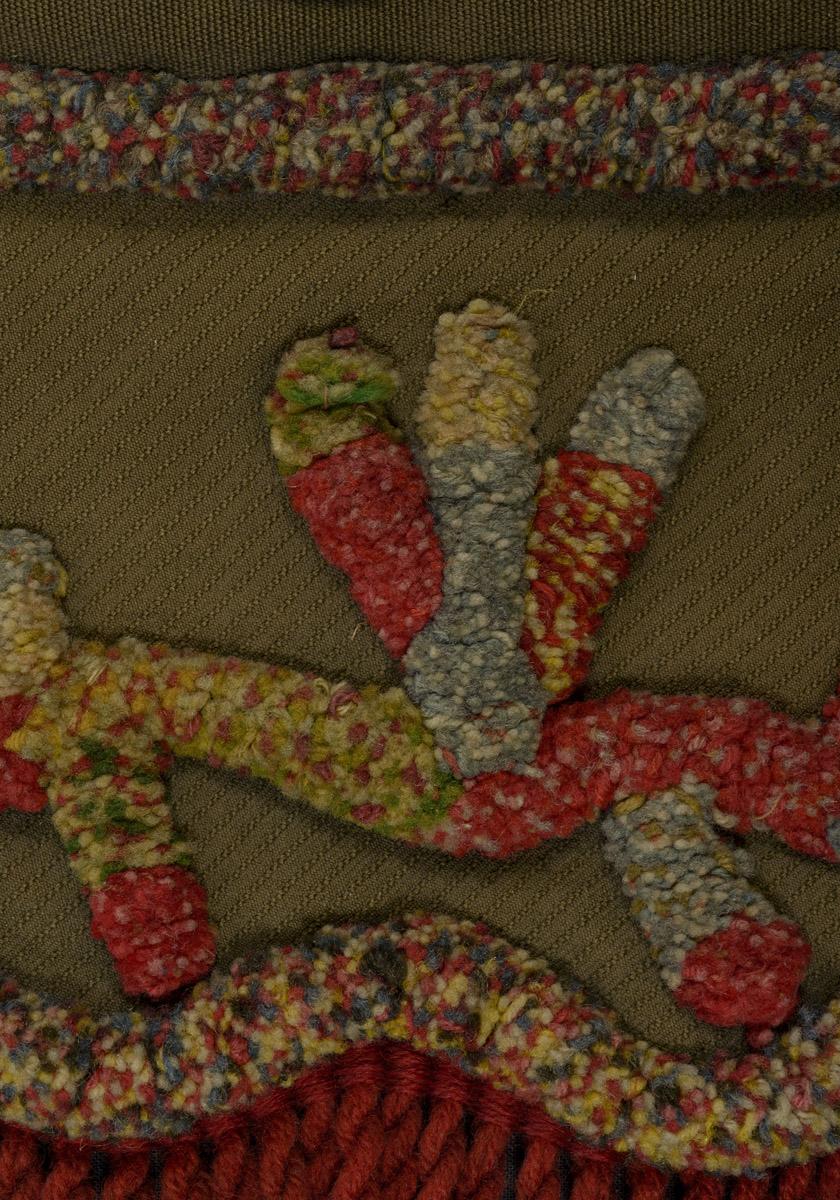 1970.1528 Chair cover, detail 2, before conservation treatment