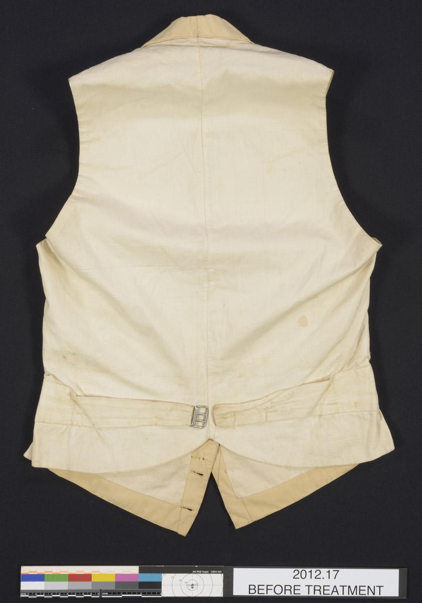 2012.0017 Waistcoat, back, before conservation treatment