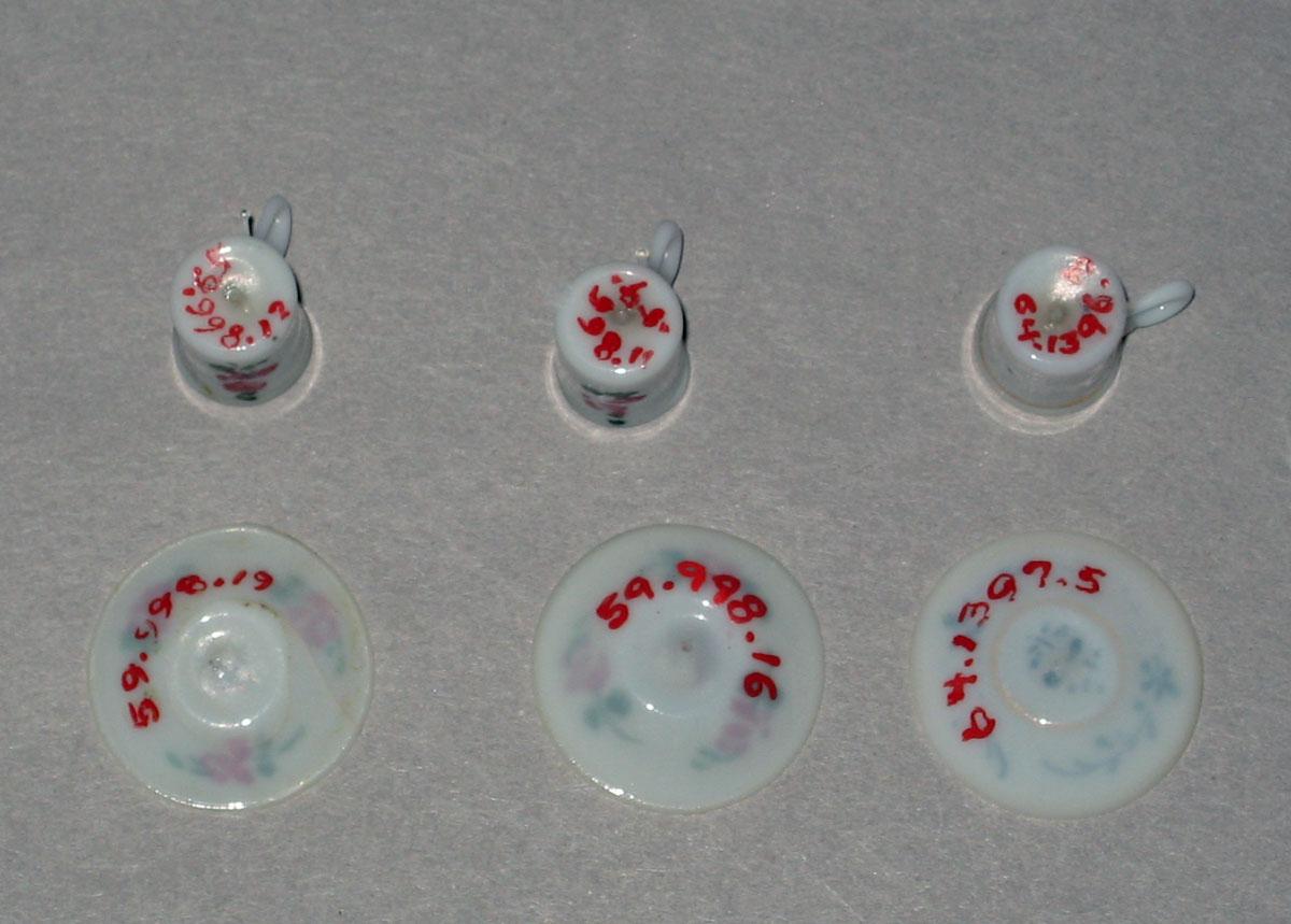 1959.0998.016, .019, .012, .011, 1964.1396.003, 1964.1397.005 Miniature glass teacups and saucers (undersides)
