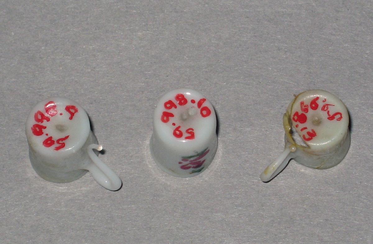 1959.0998.009, .010, .013 Miniature glass teacups (undersides)