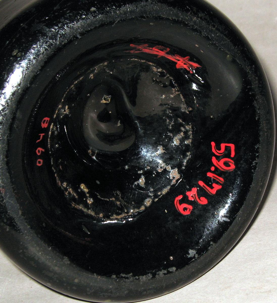 1959.1729 Glass bottle (underside)