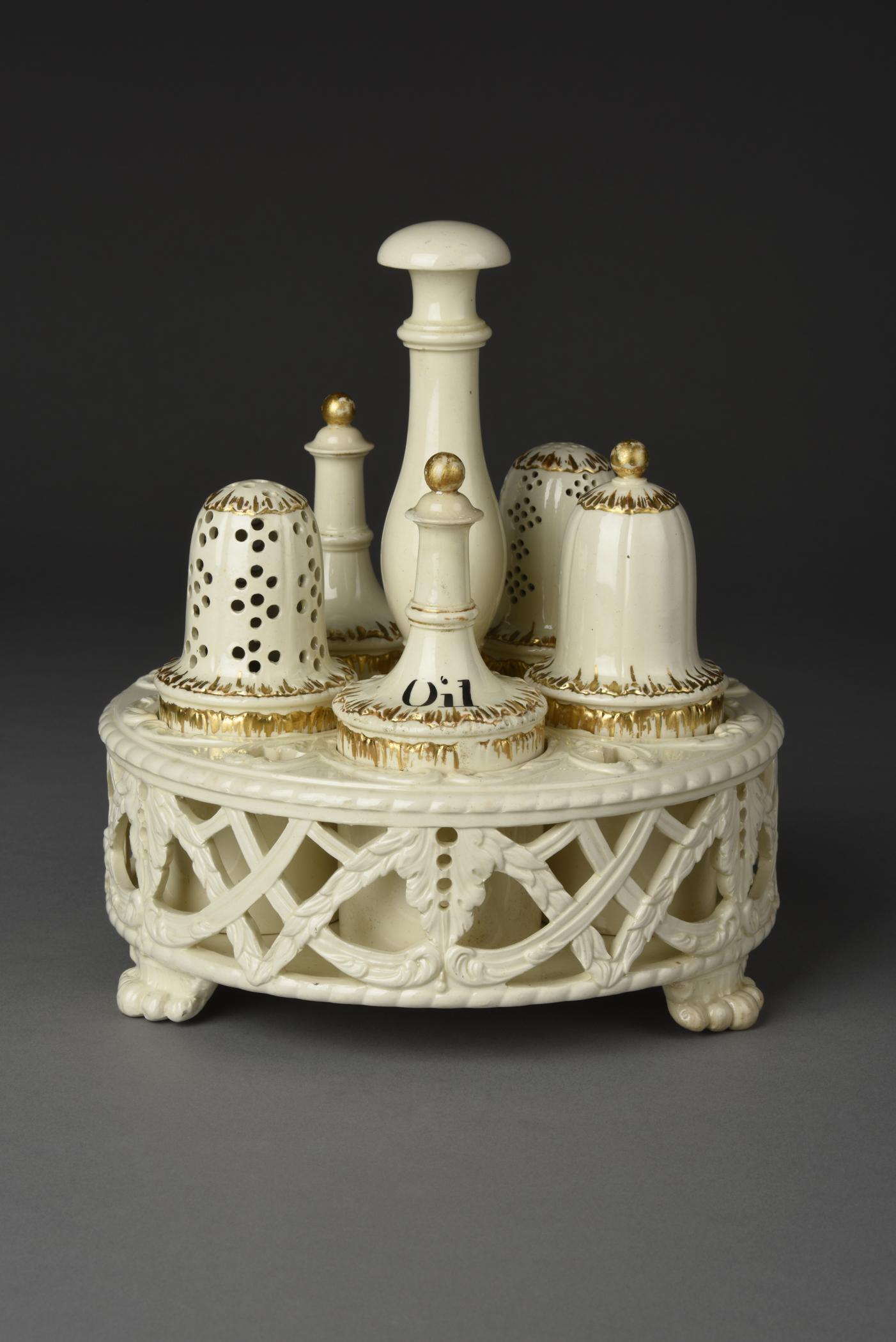 2019.0009 A Cruet frame, B, C, D, E, I, J Bottle and lid, F, G, H Caster, view 1