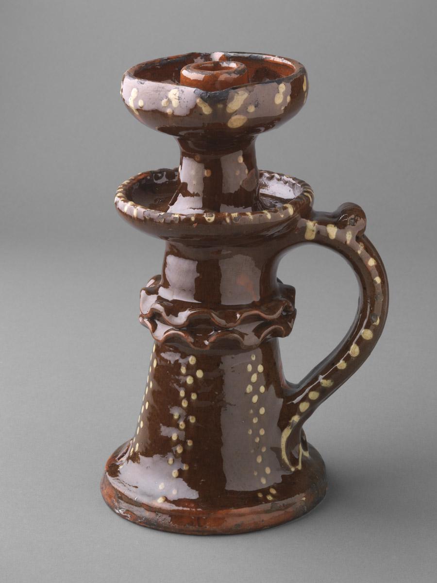 1959.2290 Redware candlestick and oil lamp