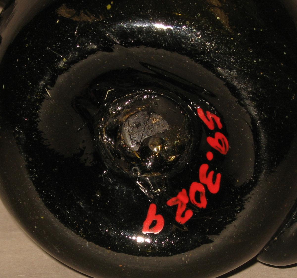 1959.3029 Glass jug (underside)