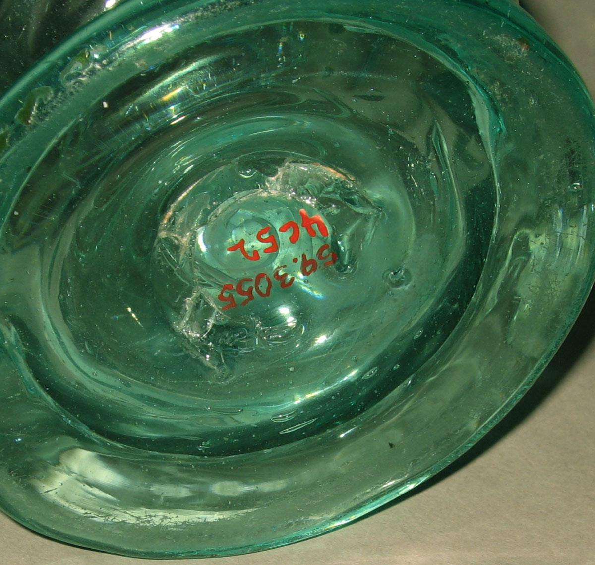 1959.3055 Free-blown glass jug (underside)