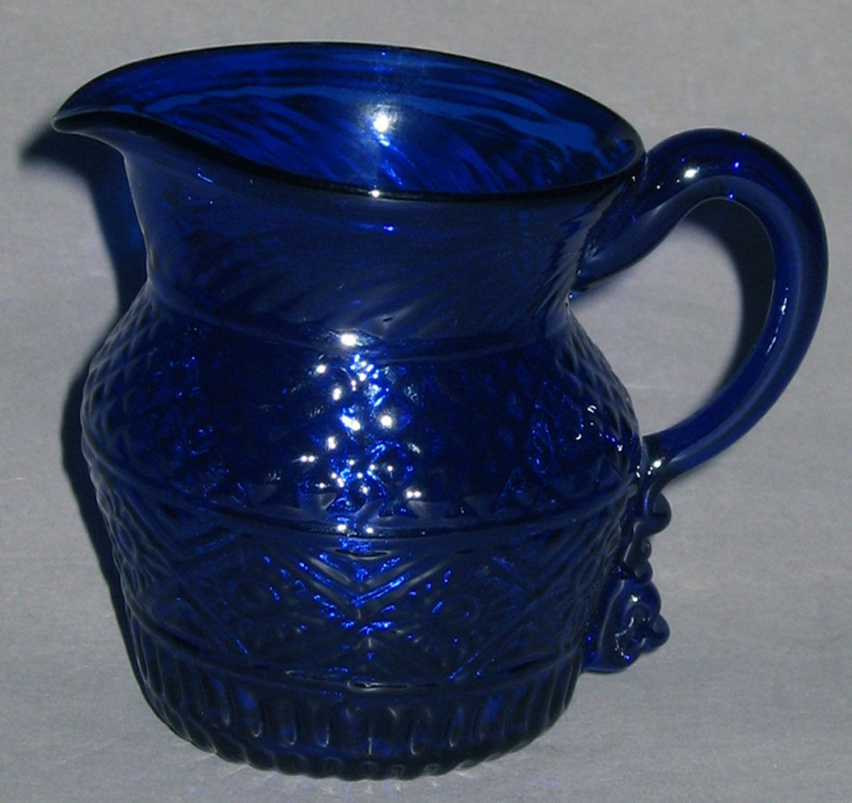 1959.3276 Blue glass cream jug (side 2)