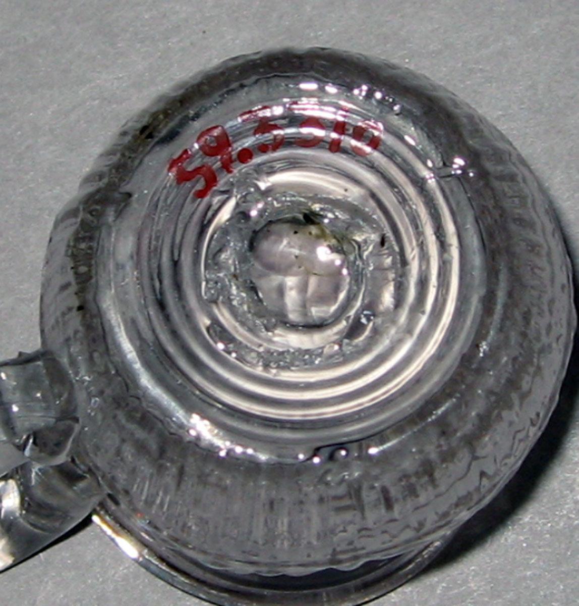1959.3310 Mold-blown colorless glass jug (underside)