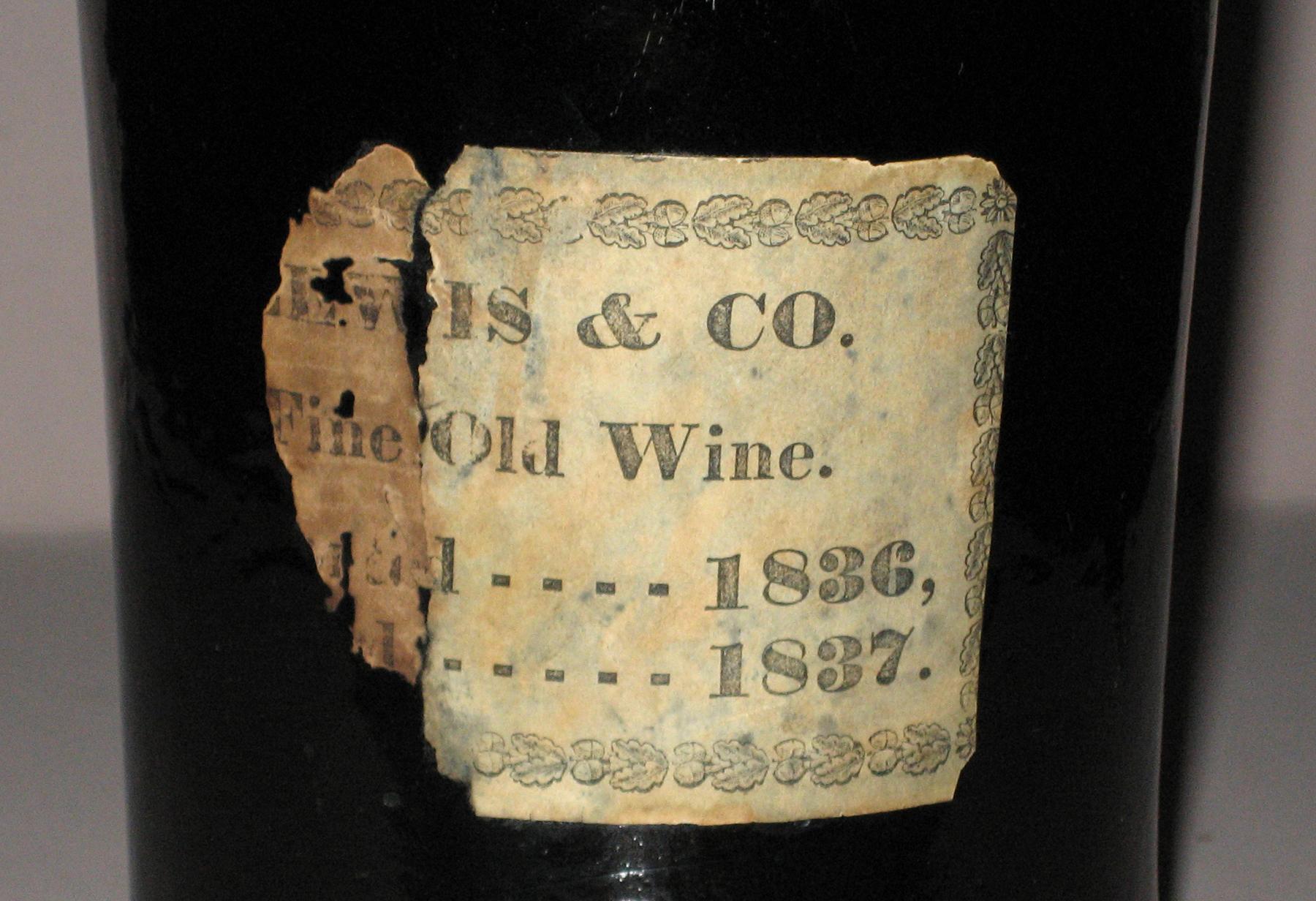 1960.0278 Wine bottle (label detail)