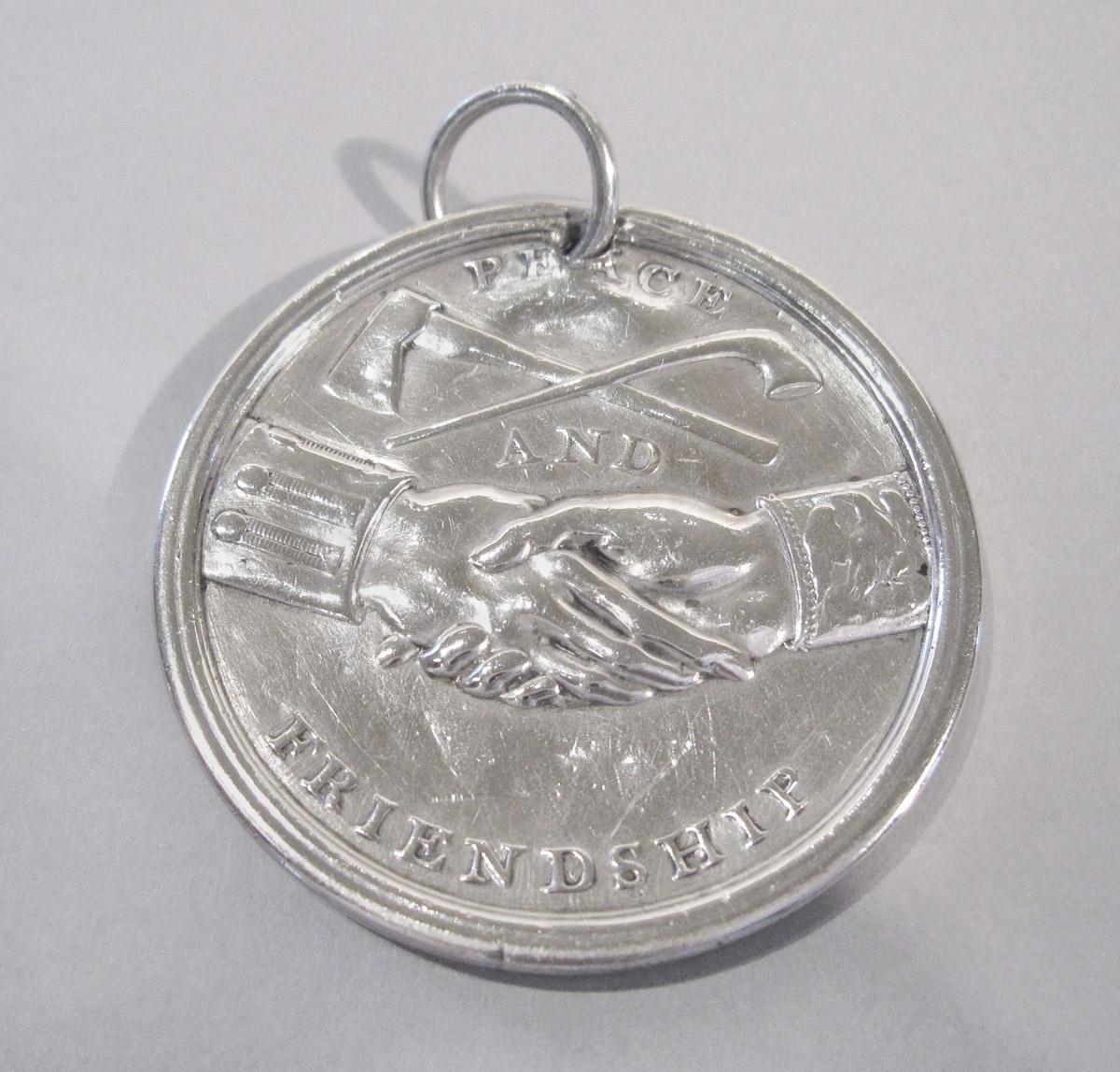 1952.0033 Medal, reverse