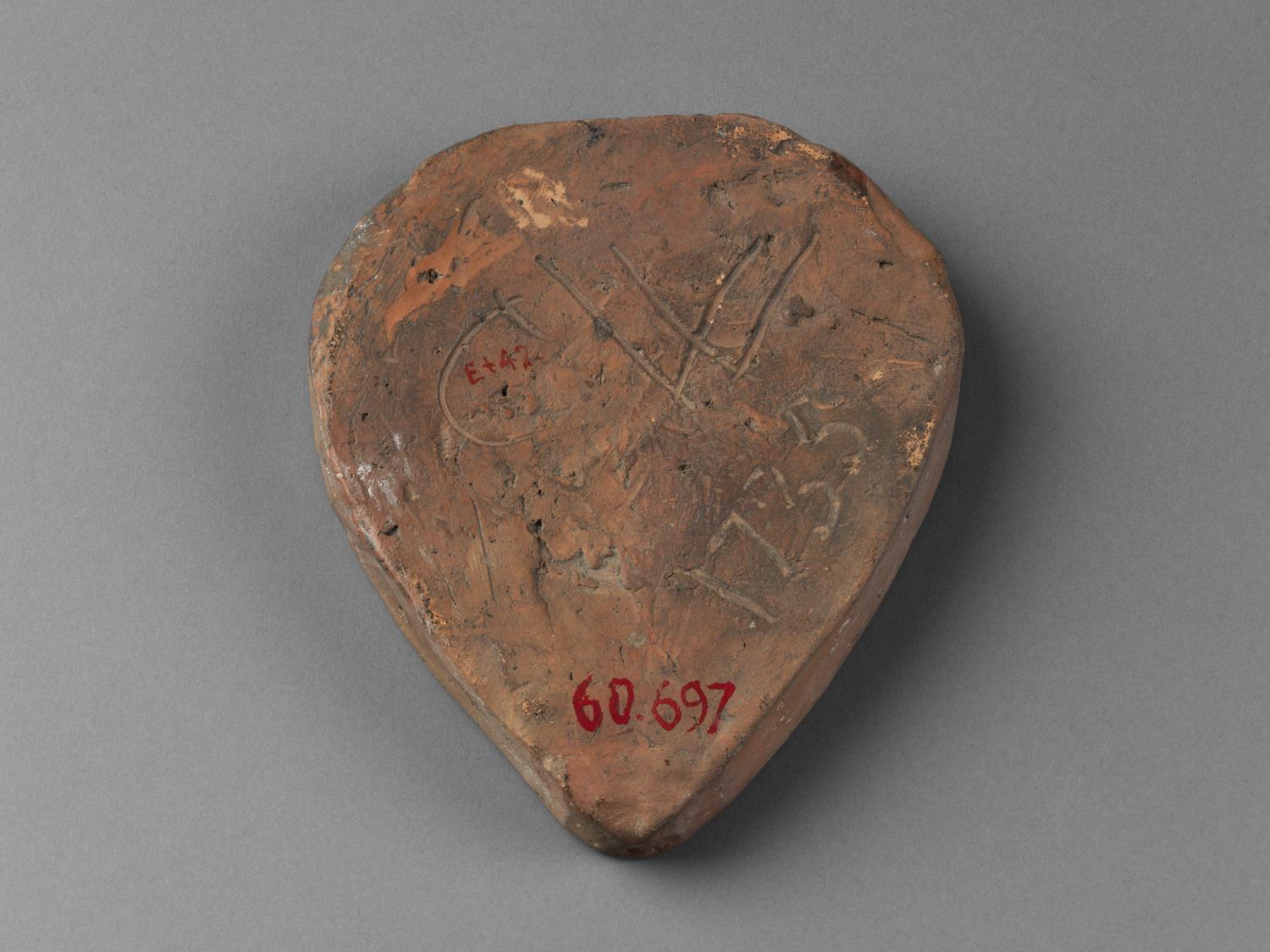 1960.0697 Earthenware heart mold (inscribed back)