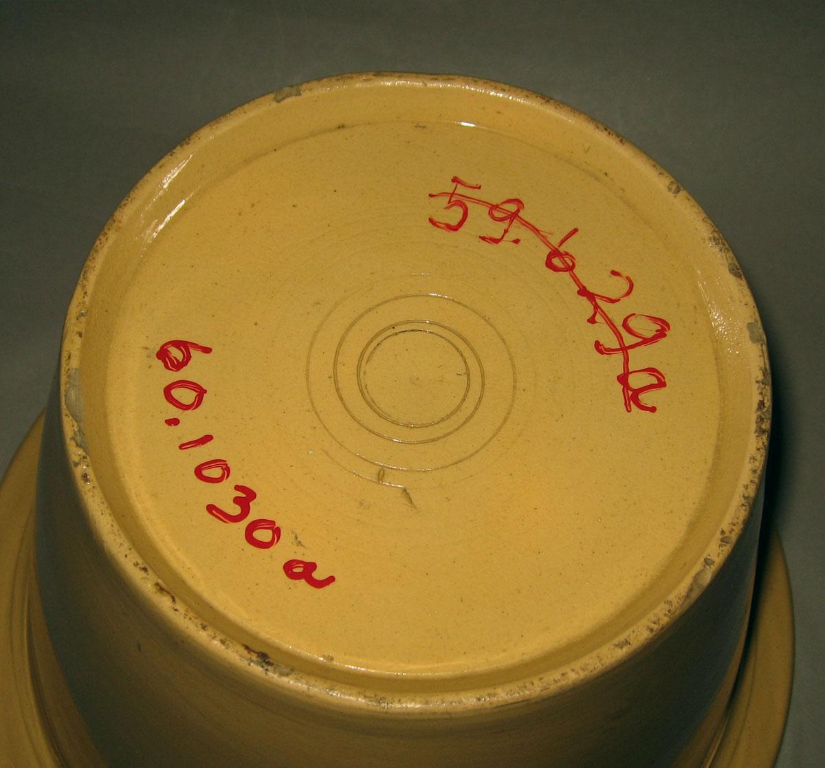 1960.1030 A Creamware chamber pot (underside)