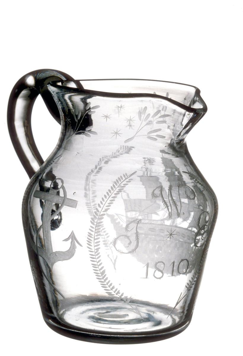 1961.0018 Glass jug (front inscription)