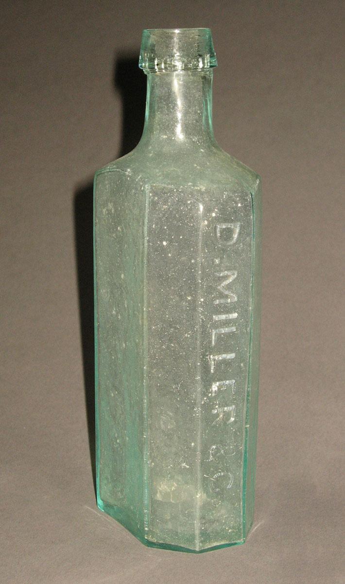 1961.0205.001 Glass syrup bottle (side 2)