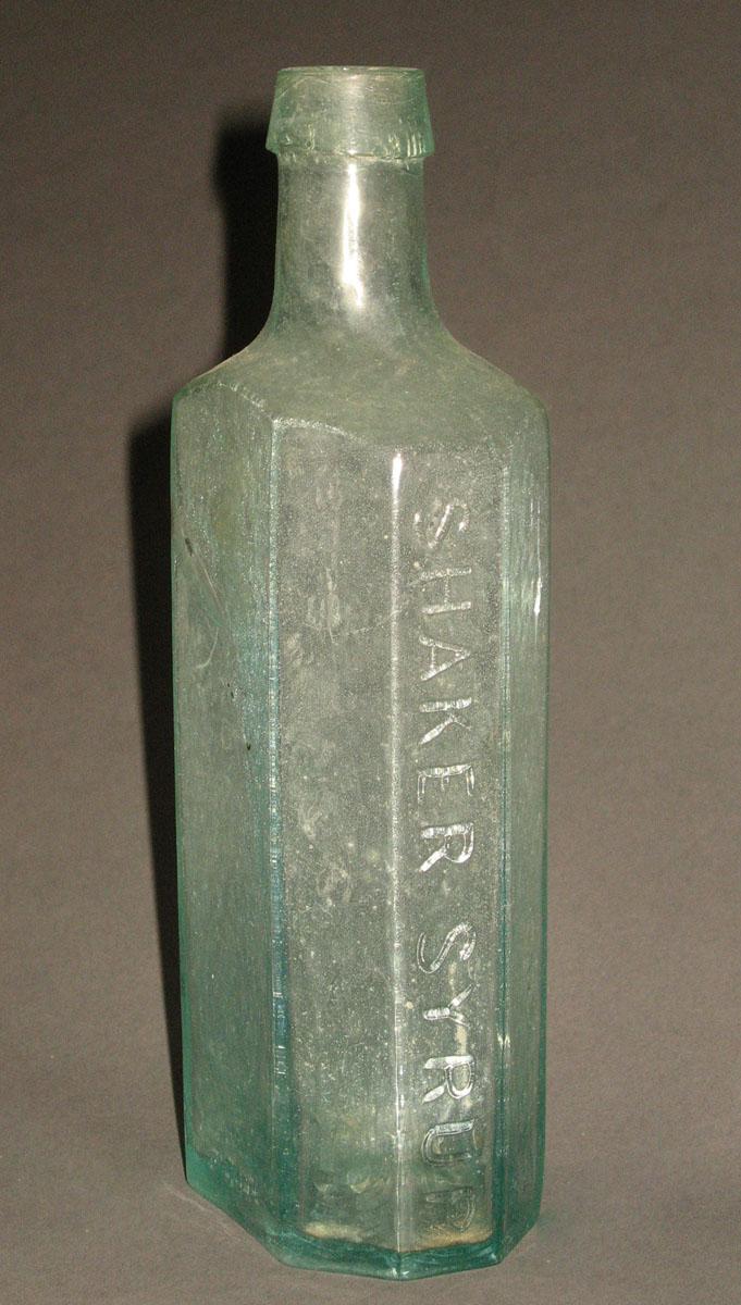 1961.0205.002 Glass syrup bottle (side 2)