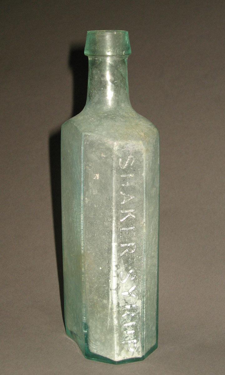 1961.0205.003 Glass syrup bottle (side 2)