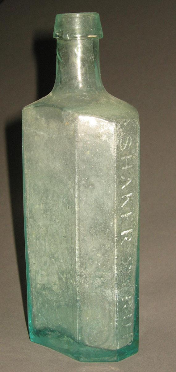 1961.0205.005 Glass syrup bottle (side 1)