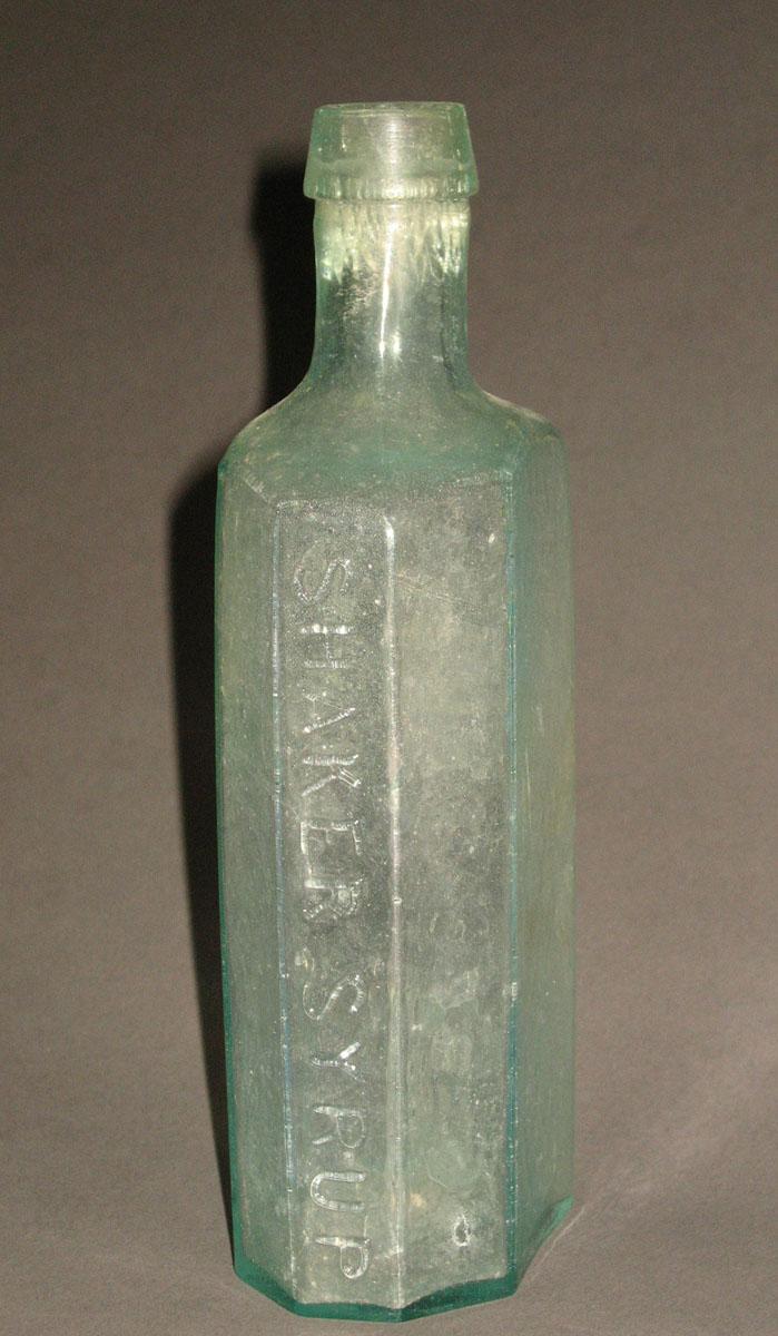 1961.0205.006 Glass syrup bottle (side 1)