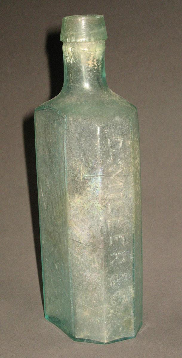 1961.0205.006 Glass syrup bottle (side 2)