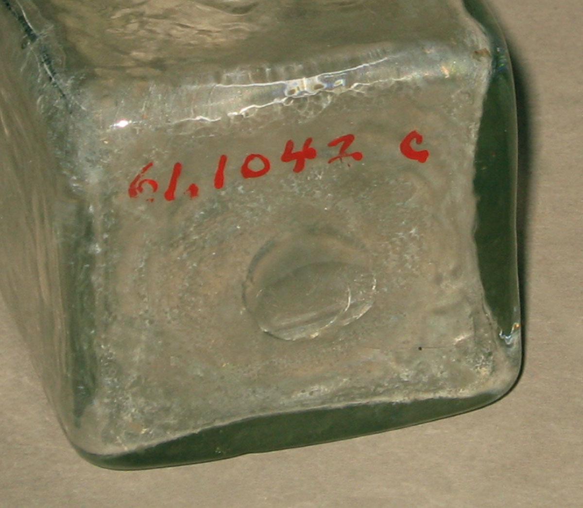 1961.1042 C Glass bottle (underside)