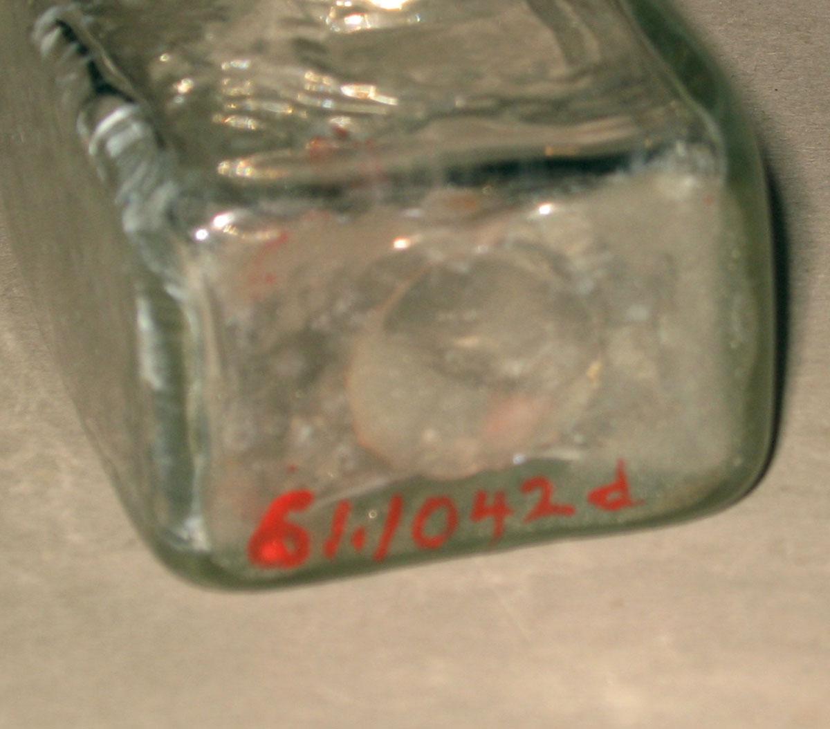 1961.1042 D Glass bottle (underside)