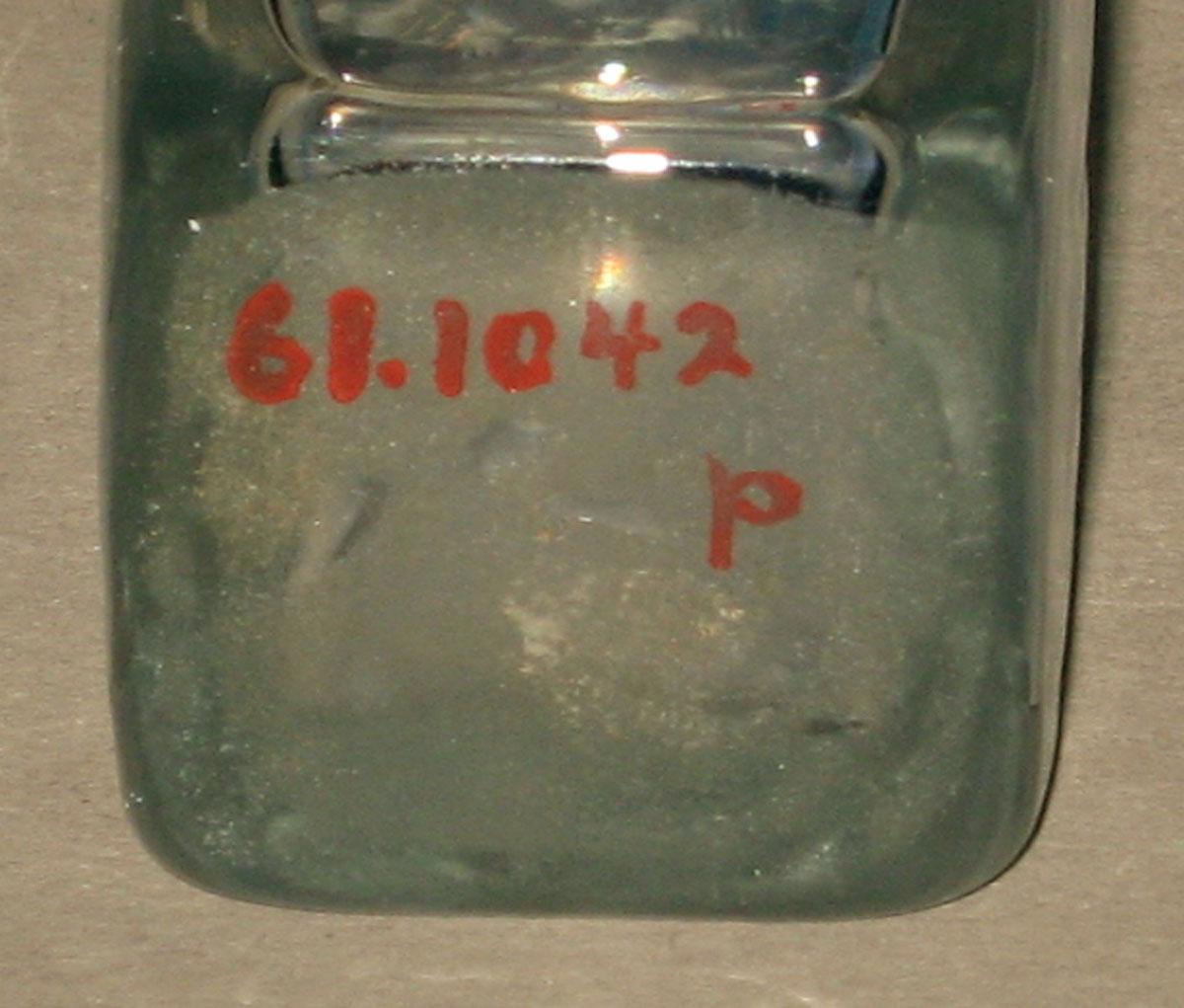 1961.1042 P Glass bottle (underside)