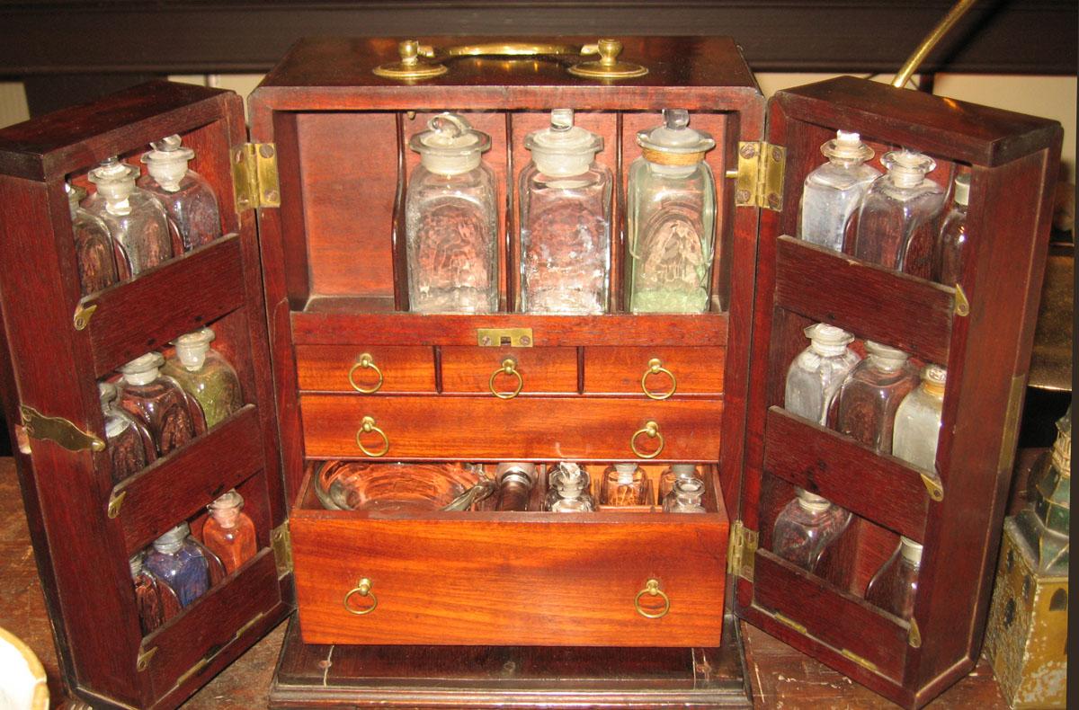 1961.1042 A- Z Wooden chest with glass bottles
