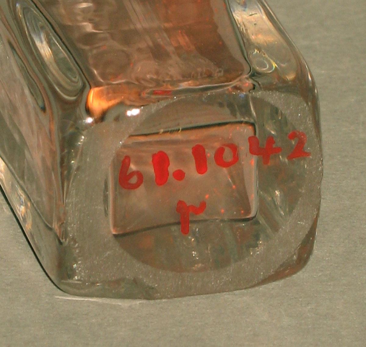 1961.1042 Glass bottle (underside)