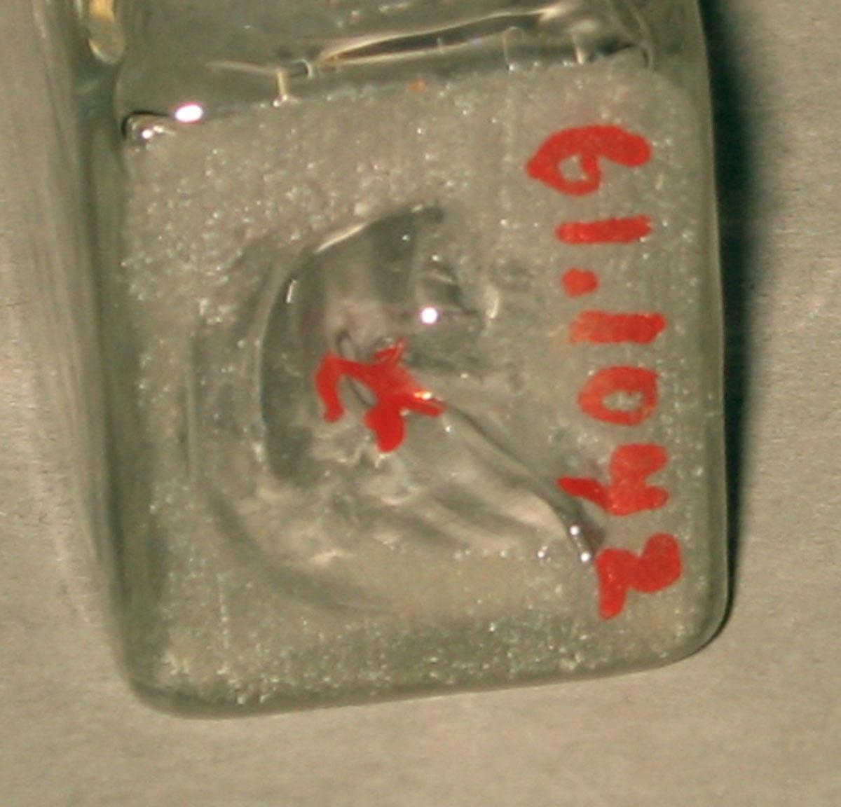 1961.1042 T Glass bottle (underside)