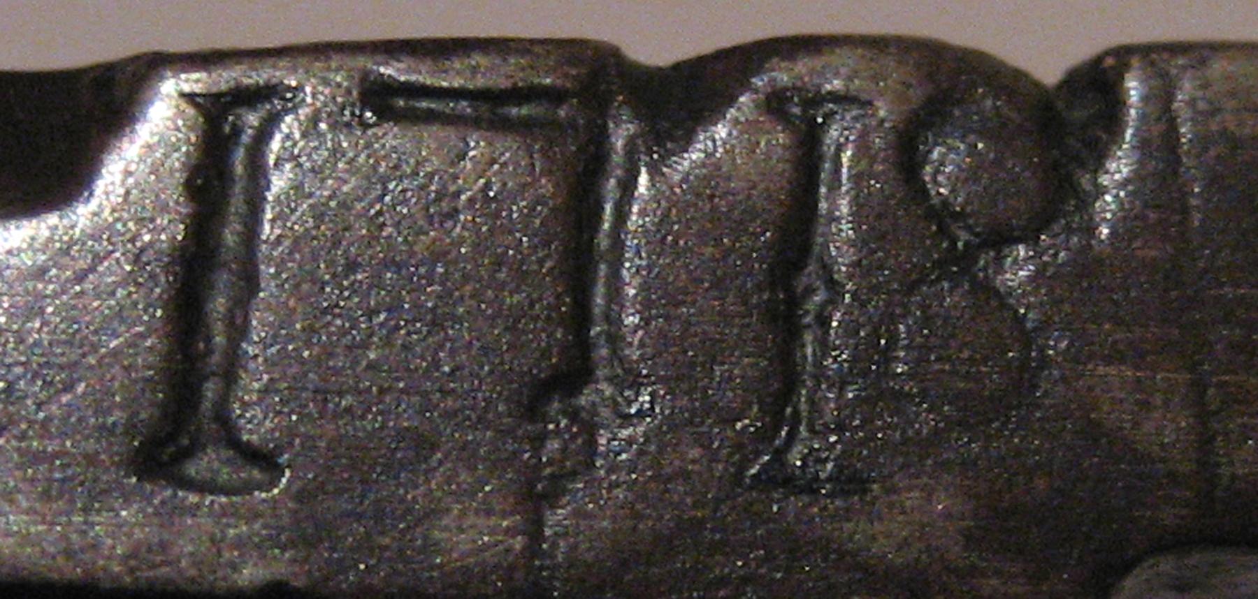 1961.1331 Tongs (mark)