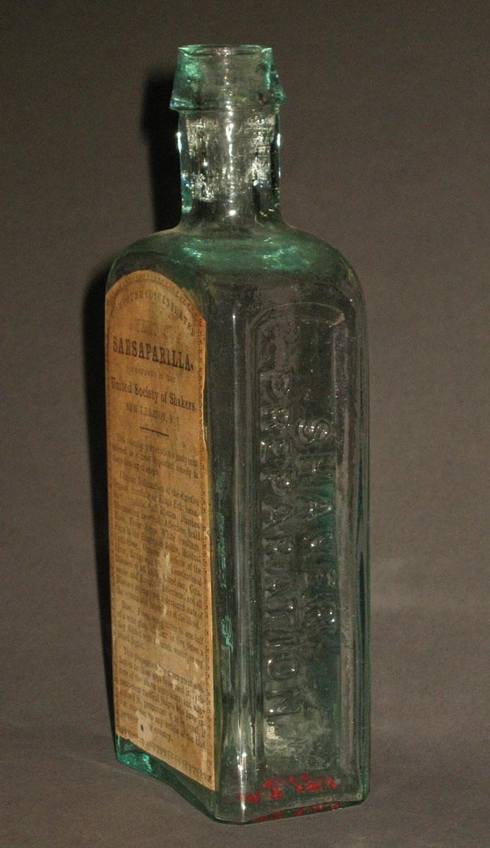 1962.0176 Glass bottle (side 1)