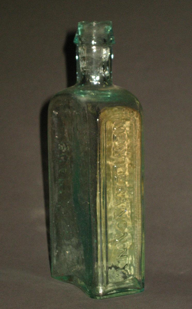 1962.0176 Glass bottle (side 2)