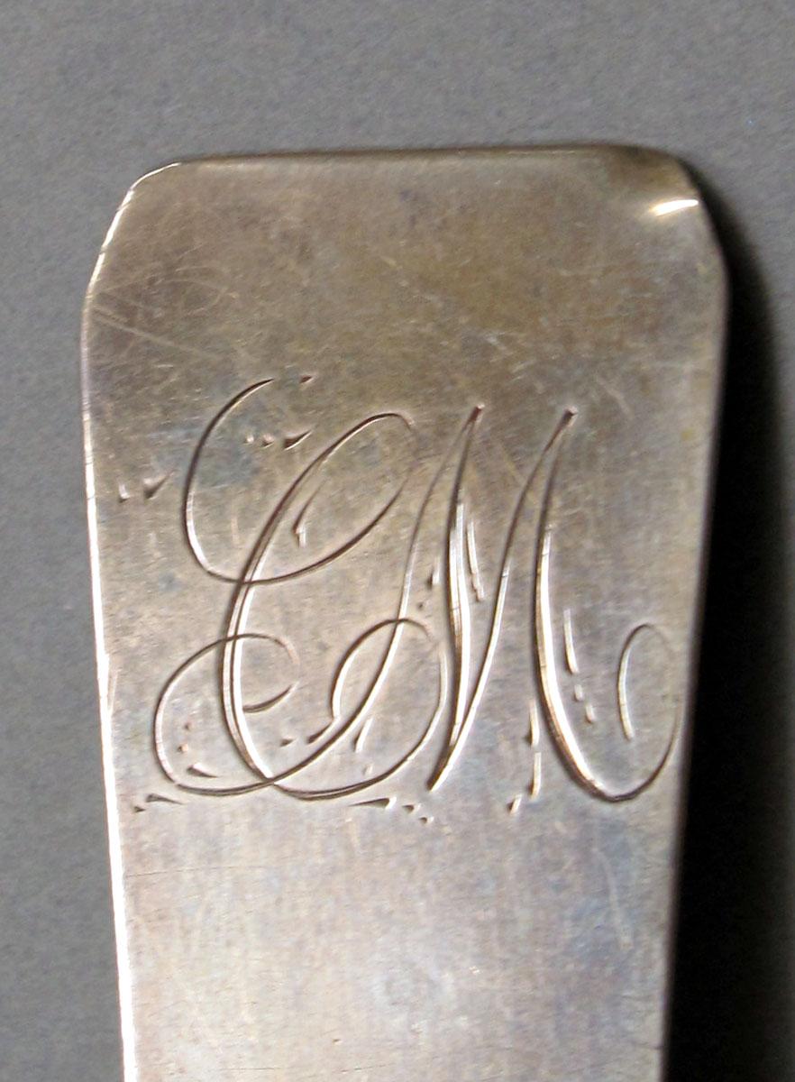 1962.0240.1051 Silver spoon engraving