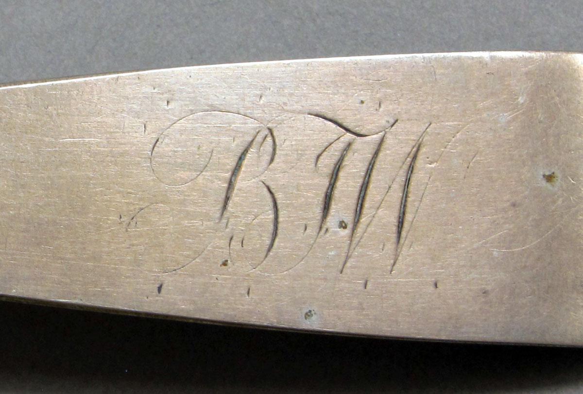 1962.0240.1054 Silver spoon engraving