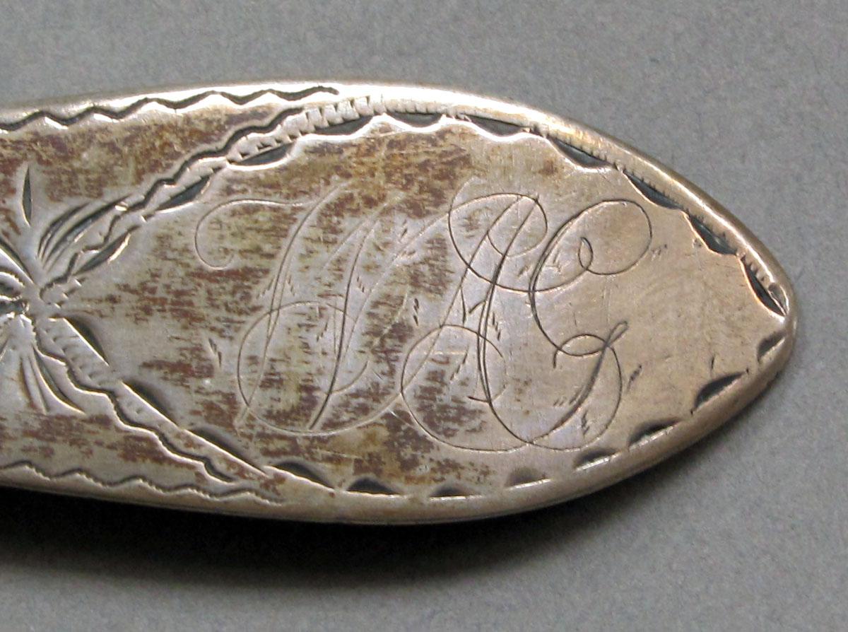 1962.0240.1059 Silver spoon engraving