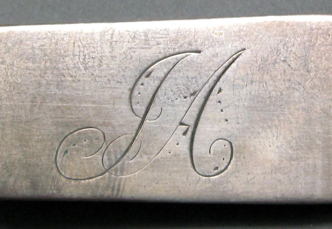 1962.0240.1062 Silver spoon engraving