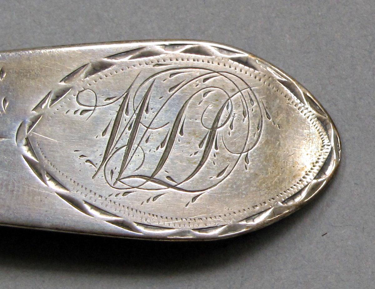 1962.0240.1067 Silver spoon engraving