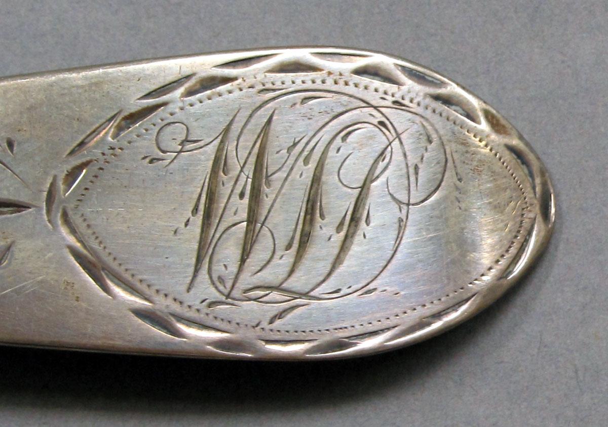 1962.0240.1076 Silver spoon engraving