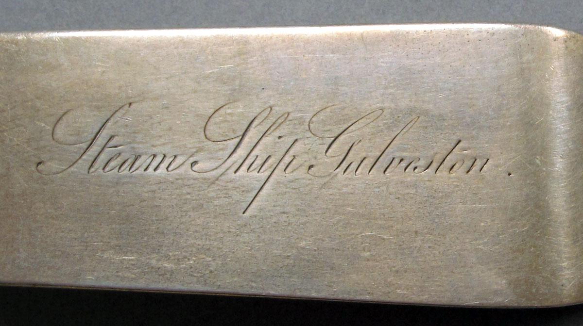 1962.0240.1082 Silver spoon engraving