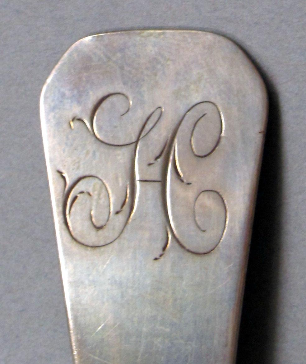 1962.0240.1086 Silver spoon engraving